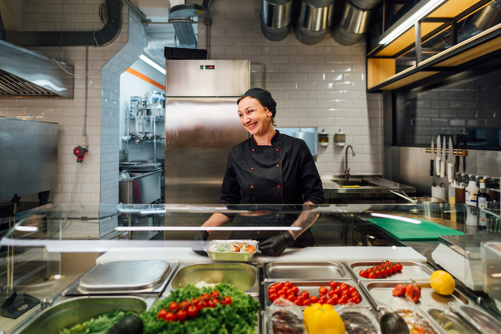 Happy caterer in kitchen